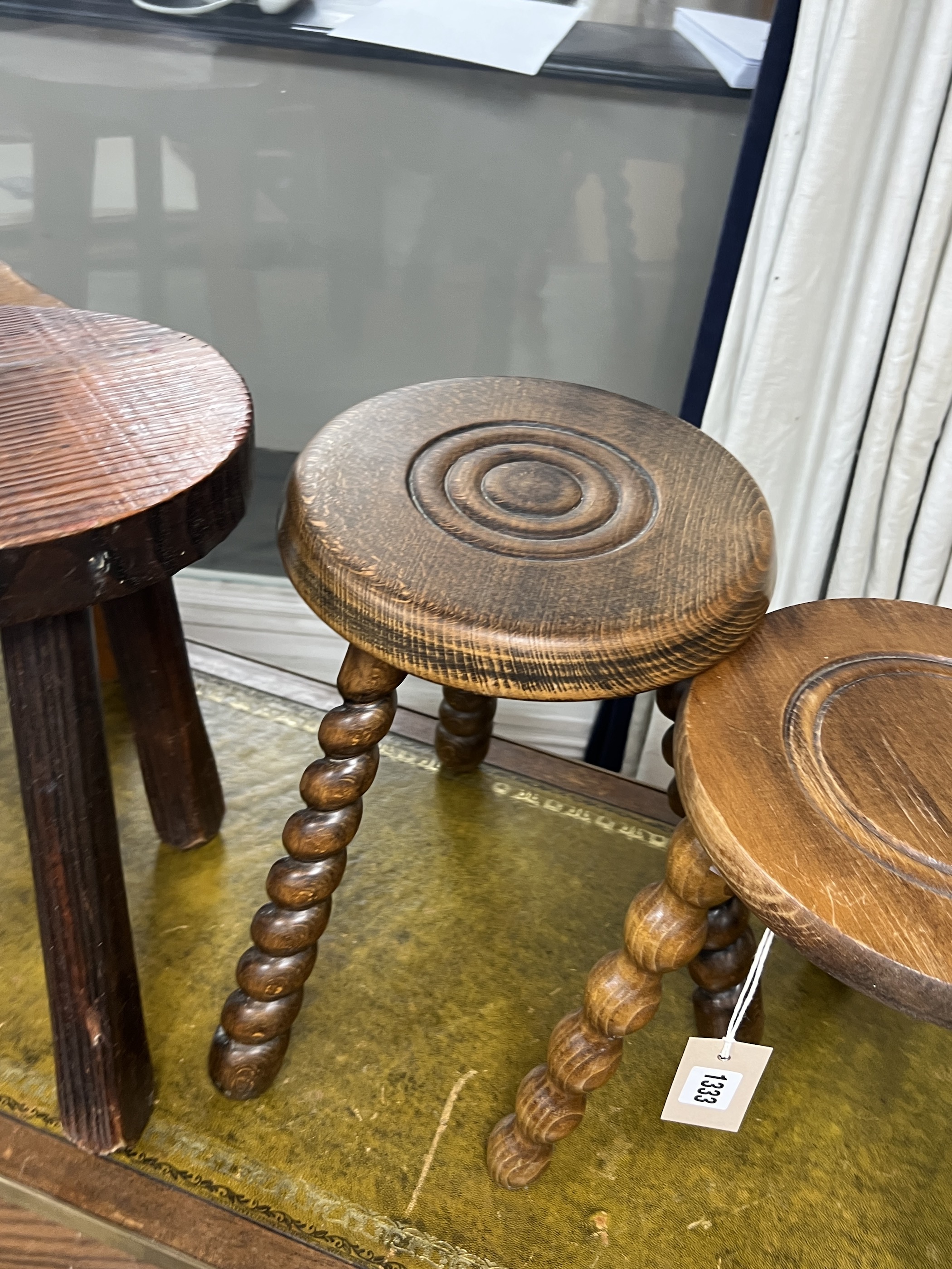 Four assorted French milking stools, largest width 24cm, height 39cm